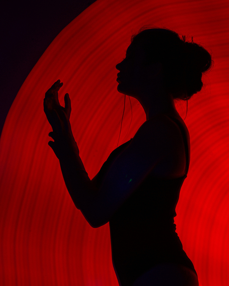 Silhouette of Woman Against Red Back